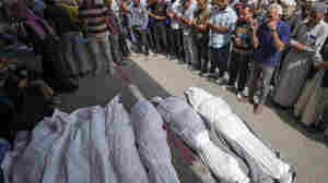 An airstrike kills 20 in central Gaza as Israel's leaders air wartime divisions